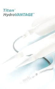 Product photograph of the cylinders and tubing of a Coloplast Titan HydroVANTAGE inflatable penile prosthesis, labelled with the device name.