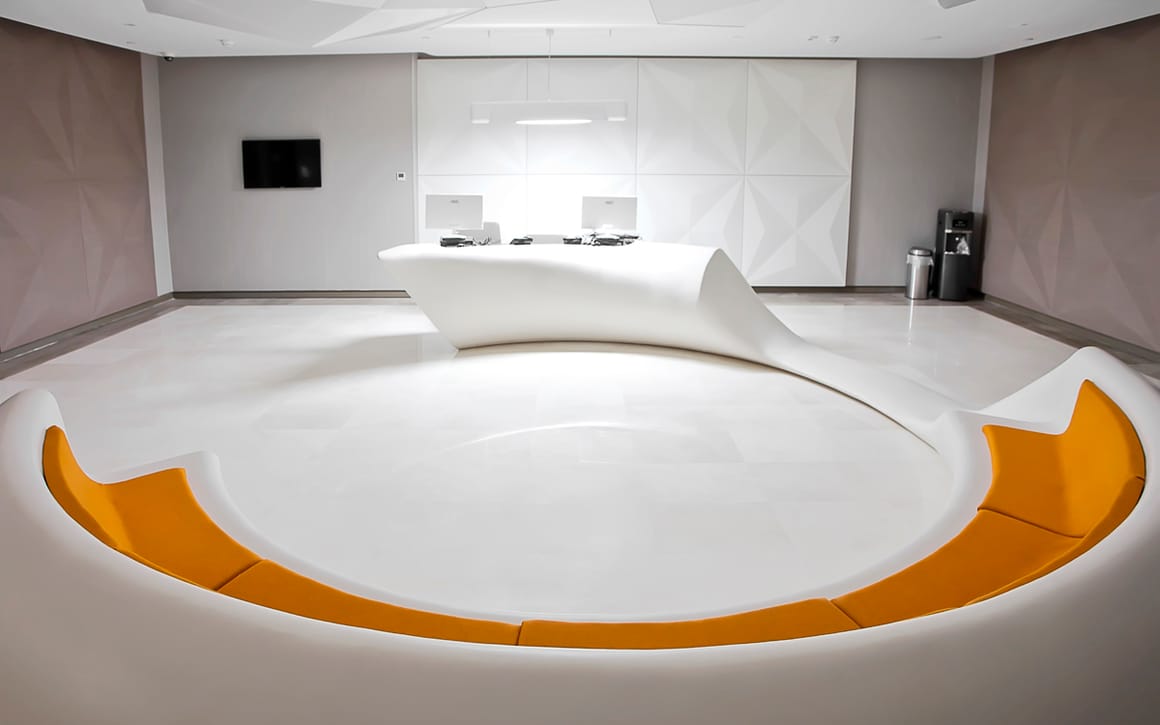 The outpatient clinic reception area at Liv Hospital Ulus in Istanbul, with a curved white desk and seating.