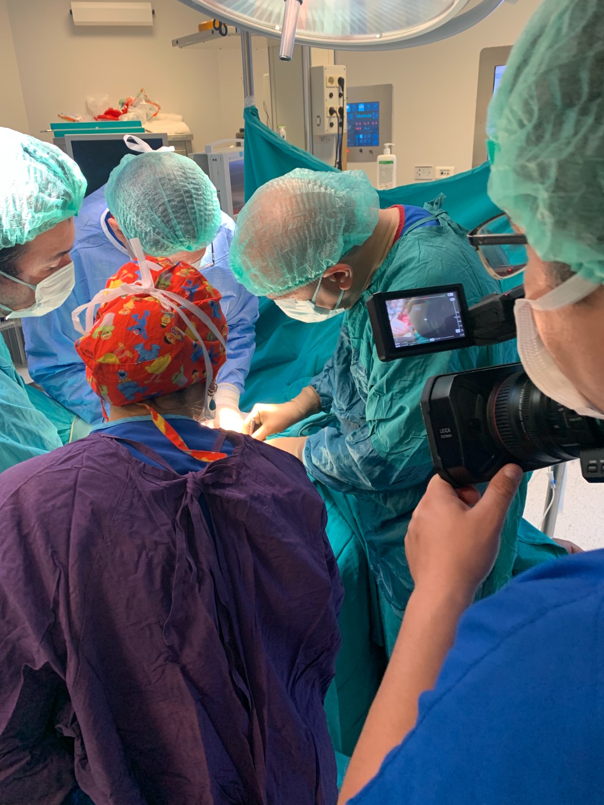 A multidisciplinary surgical team working in a modern operating theatre.